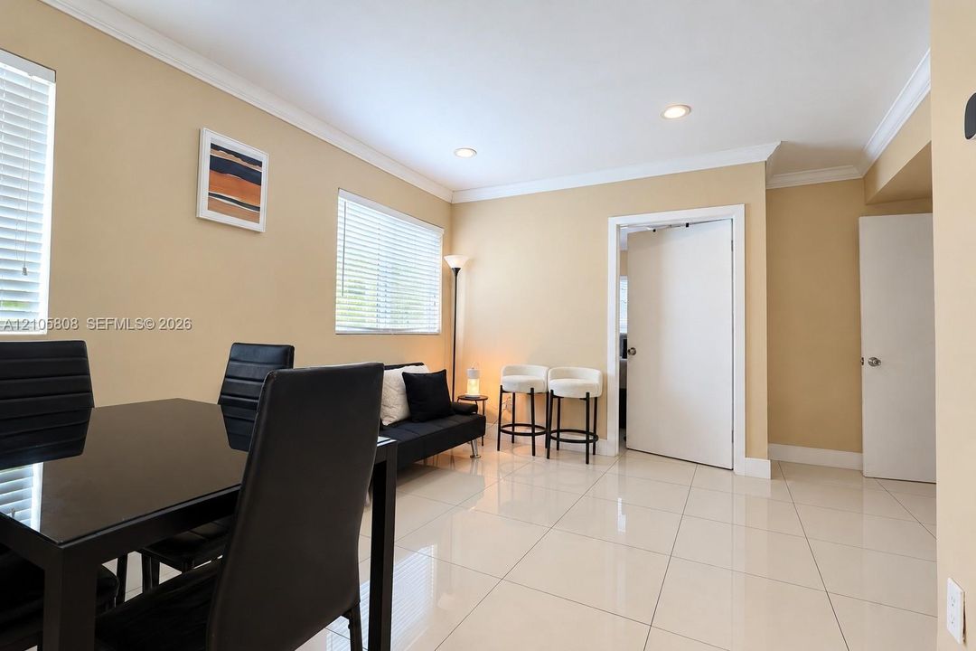Ceramic tile flooring, recessed lighting, and crown molding