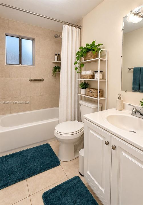 White vanity cabinet with an integrated basin, tub and shower combination featuring neutral-toned tile surround, built-in wall niches, and a polished chrome wall-mounted light fixture above the vanity mirror