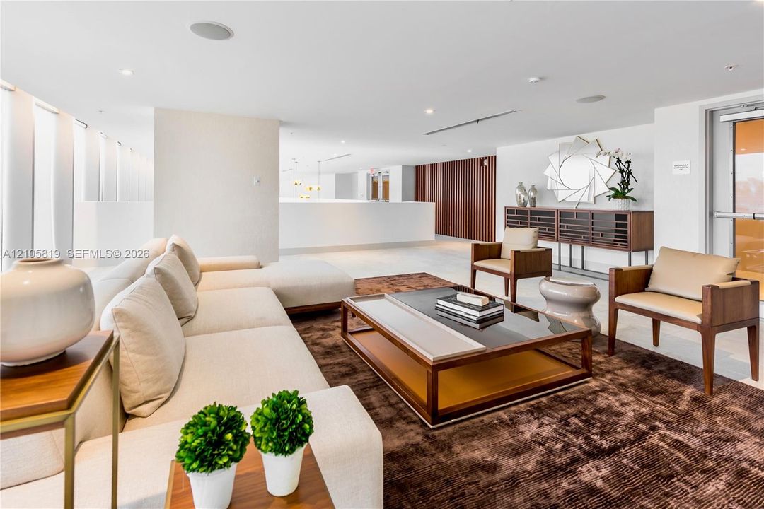 Open-concept interior featuring recessed lighting, floor-to-ceiling windows, and wood-paneled wall detailing
