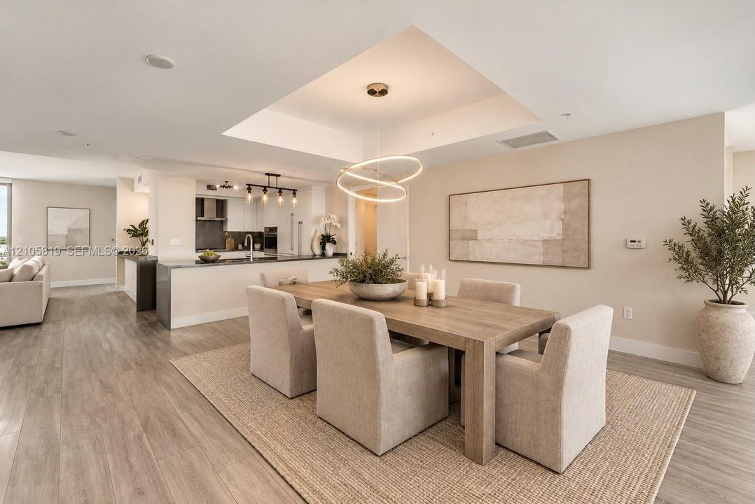 Open-concept Dining Room featuring a tray ceiling.