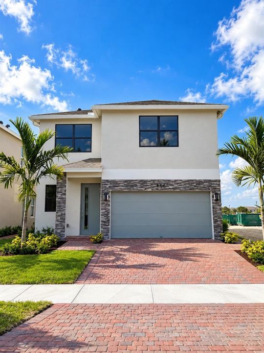 Two-story exterior featuring a light-toned stucco facade, stone veneer accents, a paver driveway, and a two-car garage