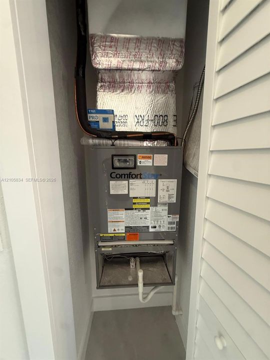 ComfortStar air handling unit featuring reflective duct insulation and louvered closet door enclosure