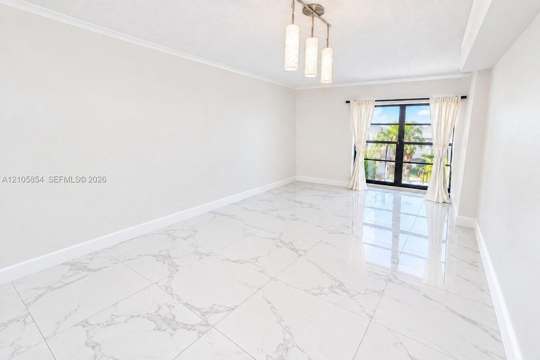 Edited image showing how the room would look without furniture, highlighting its spacious layout, beautiful flooring and stunning lake view.