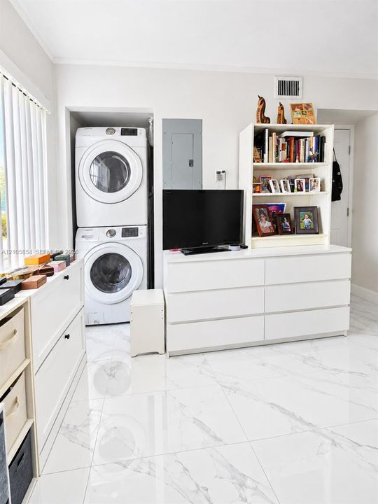 A first-floor bedroom and full bathroom provide flexibility for guests, family, or a home office. Laundry closet is inside bedroom.