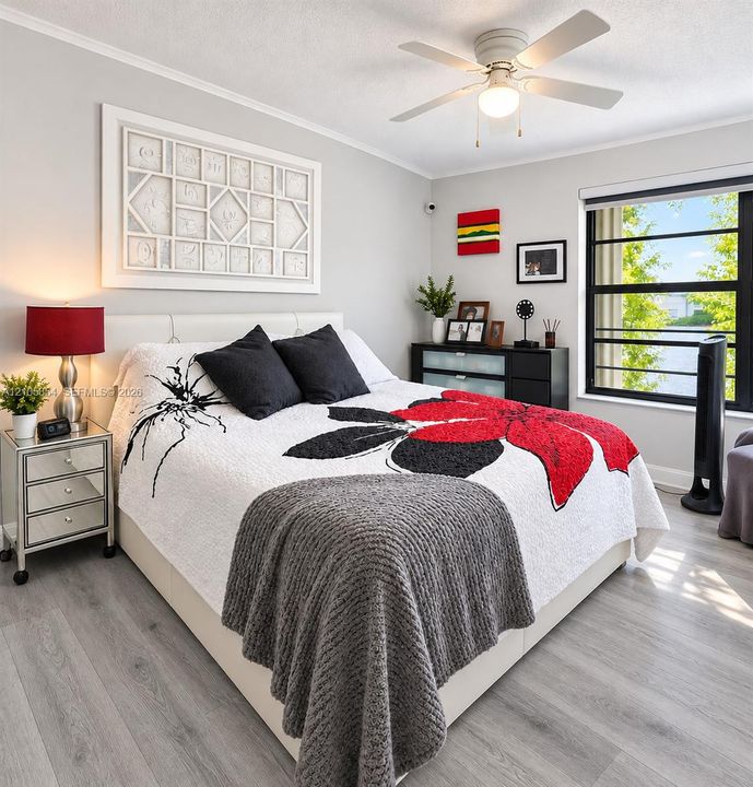Spacious master bedroom features electric blinds
