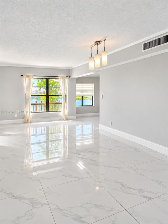 Edited image showing how the room would look without furniture, highlighting its spacious layout, beautiful flooring and stunning lake view.