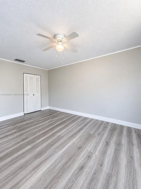 Edited image showing how the room would look without furniture, highlighting its spacious layout and beautiful flooring