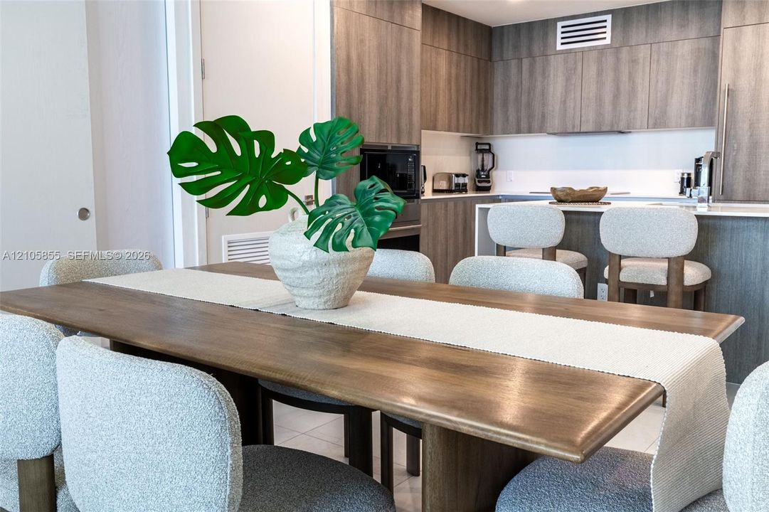 Kitchen featuring wood-finish cabinetry, stone countertops, and a breakfast bar