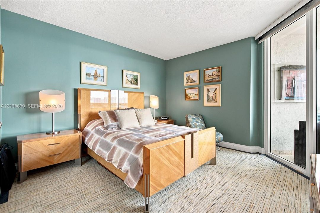 Textured carpeting, full-height glass sliding doors, and neutral wall tones