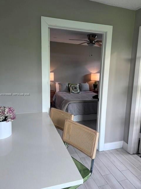 1/1 area White solid-surface countertop with wood-finish flooring and a central ceiling fan