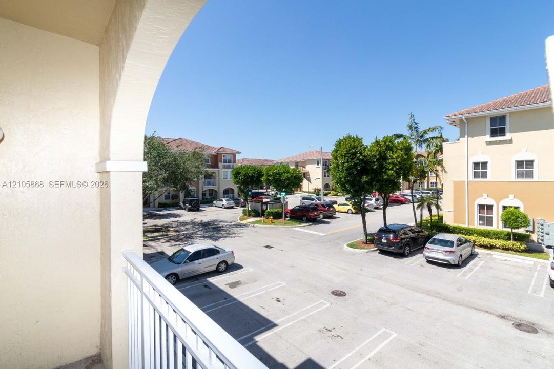 Covered balcony with white metal railing and arched architectural detail