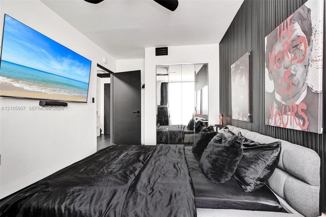 Vertical slat accent wall, mirrored closet doors, and solid-core black interior door