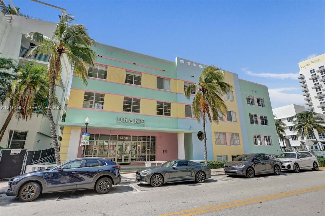 Art Deco exterior featuring a multi-story pastel facade, recessed window groupings, and a symmetrical geometric design