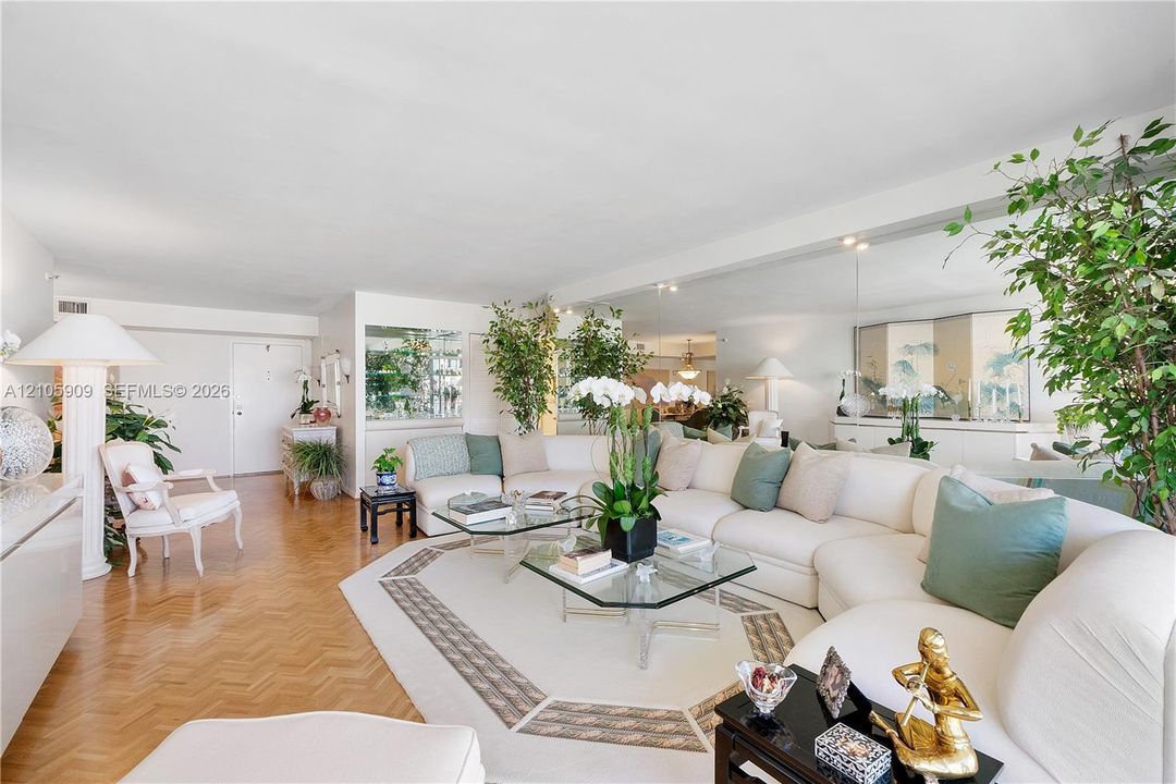 Parquet wood-finish flooring, extensive wall-to-wall mirrors, and crisp white architectural walls