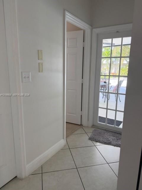 Tile flooring, multi-pane glass door, and interior paneled doors