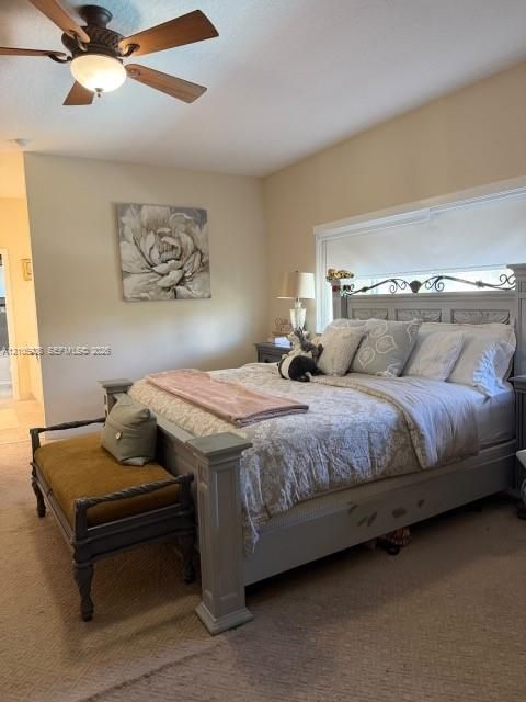 Room featuring neutral wall tones, wall-to-wall carpeting, and a ceiling fan with integrated lighting