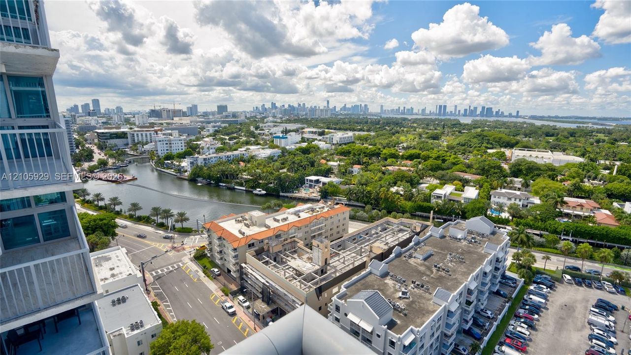 High-rise balcony featuring metal railings with extensive urban, canal, and cityscape outlooks
