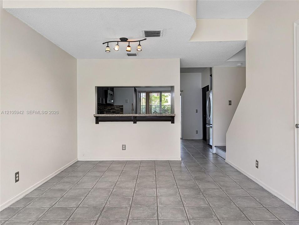 living ceramic floor tile, vaulted ceilings, a ceiling fan with integrated lighting