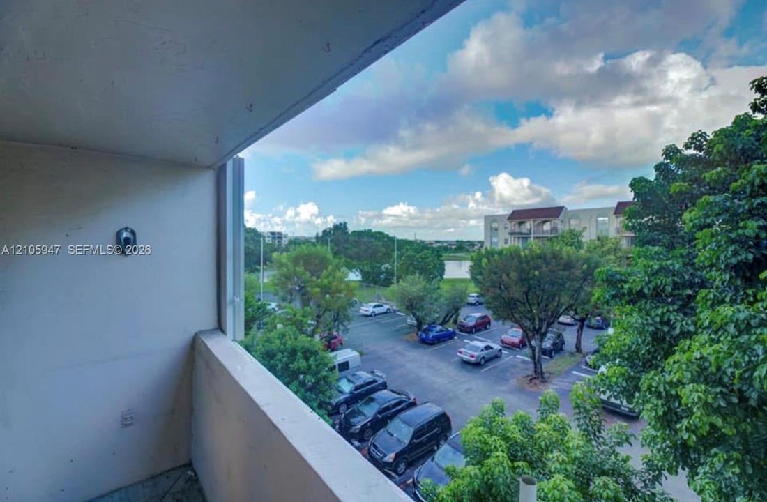 Covered balcony with a solid perimeter wall and mounted exterior light fixture