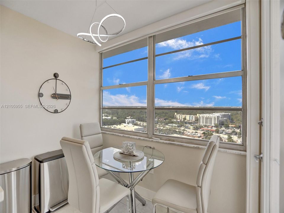 Large windows featuring expansive exterior scenery, contemporary circular LED light fixture, and stone window sill