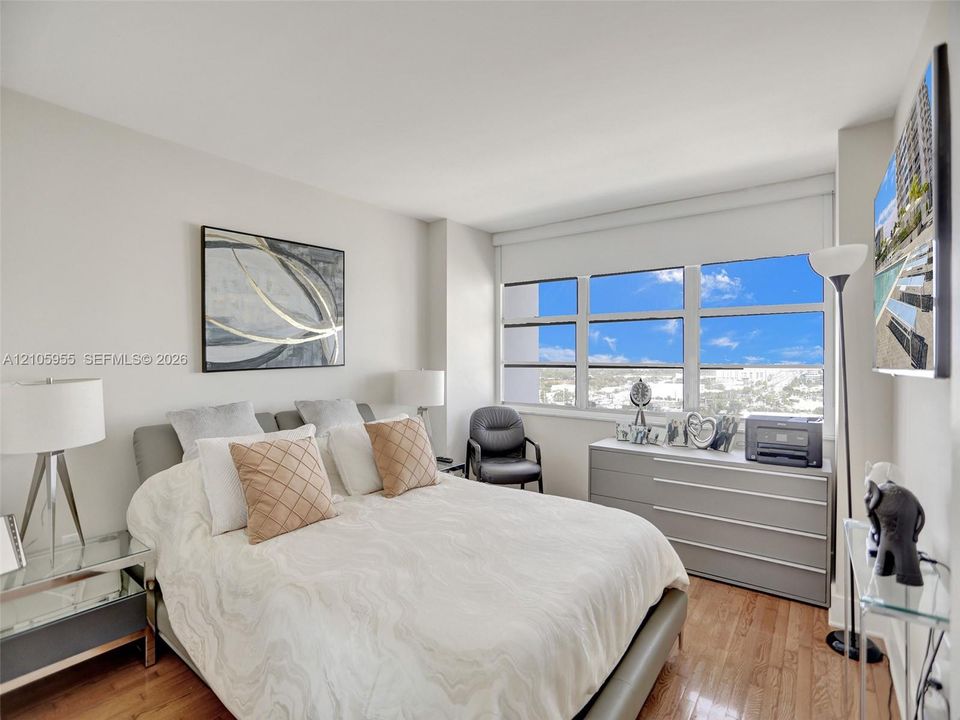 Wood-finish flooring, large multi-pane windows, and neutral wall tones