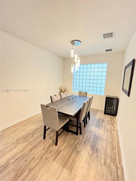 Wood-finish flooring, glass block window, and multi-pendant light fixture