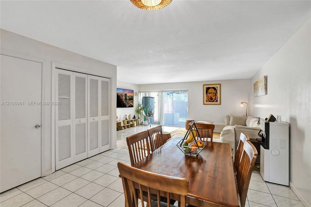 Ceramic tile flooring, louvered bi-fold closet doors, and sliding glass patio door