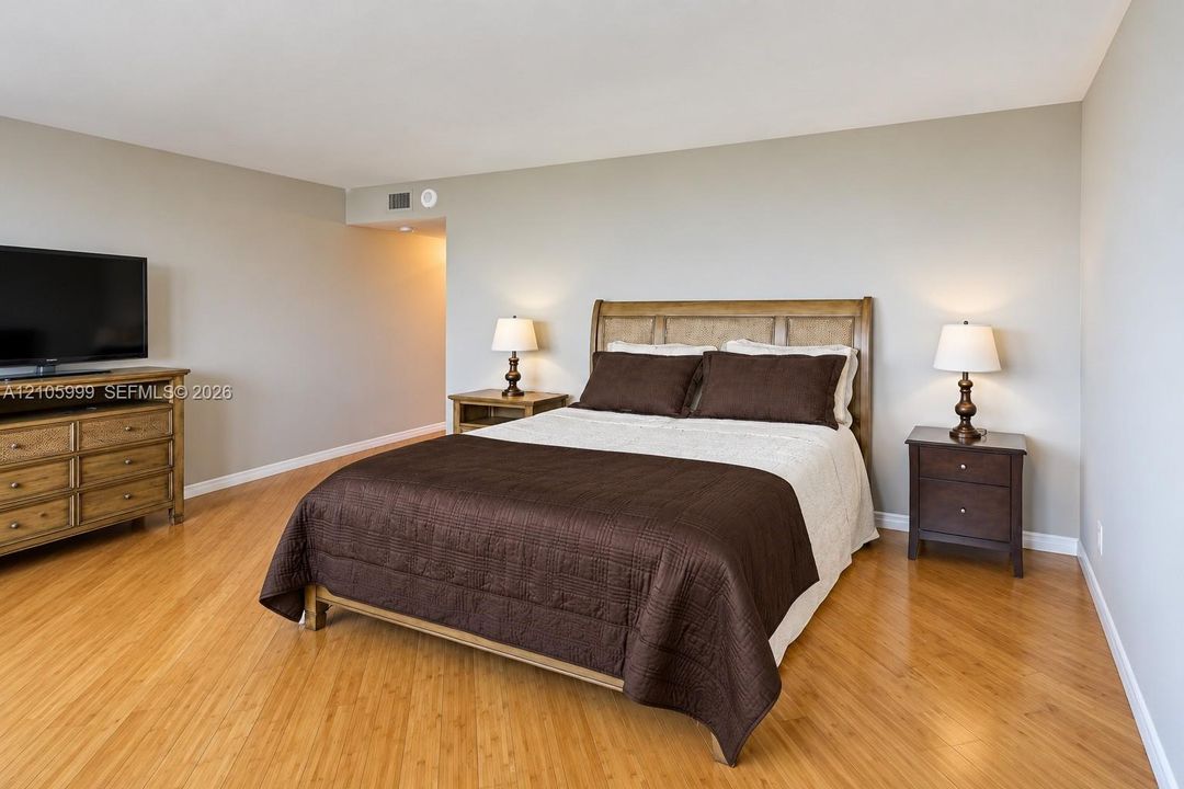 Spacious room featuring light wood-finish flooring and neutral wall paint
