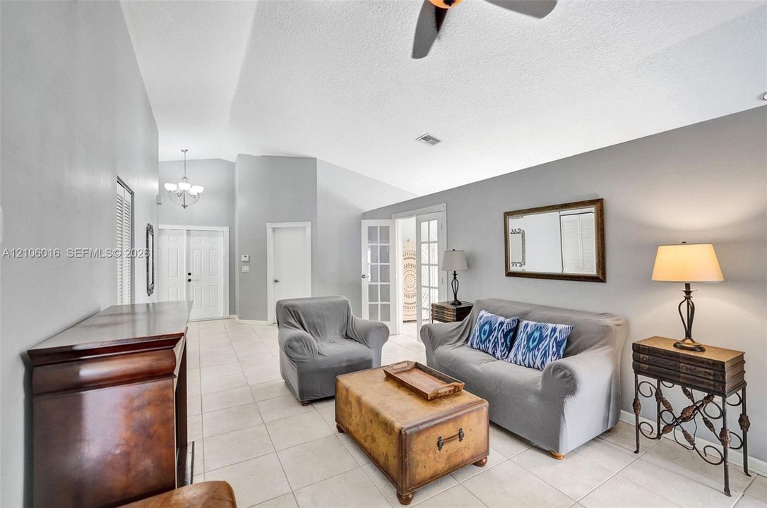 Vaulted ceilings, ceramic tile flooring, French doors with glass panes, and double entry doors