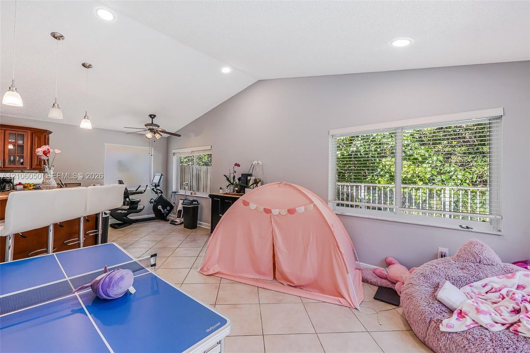 Vaulted ceilings, tile flooring, recessed lighting, pendant lighting, and horizontal window blinds