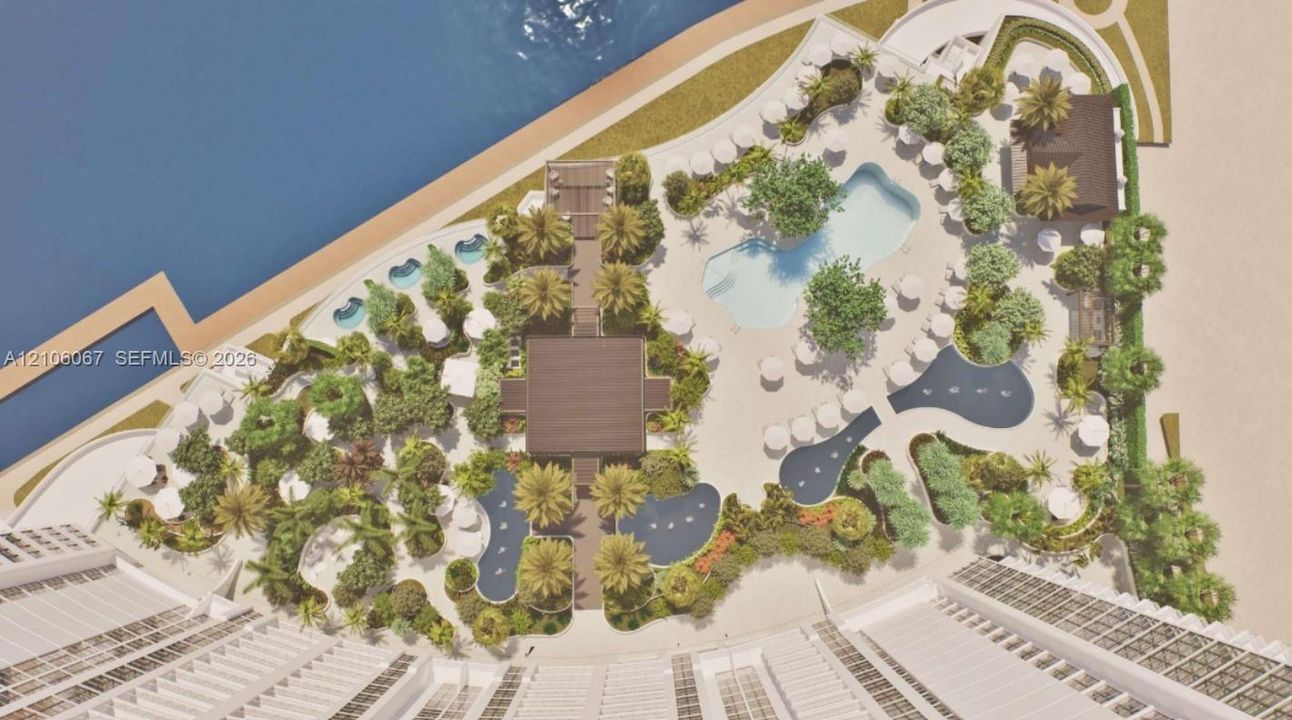 Aerial view of a waterfront recreation complex featuring a swimming pool, multiple water features, palm-lined landscaping, and a central pavilion