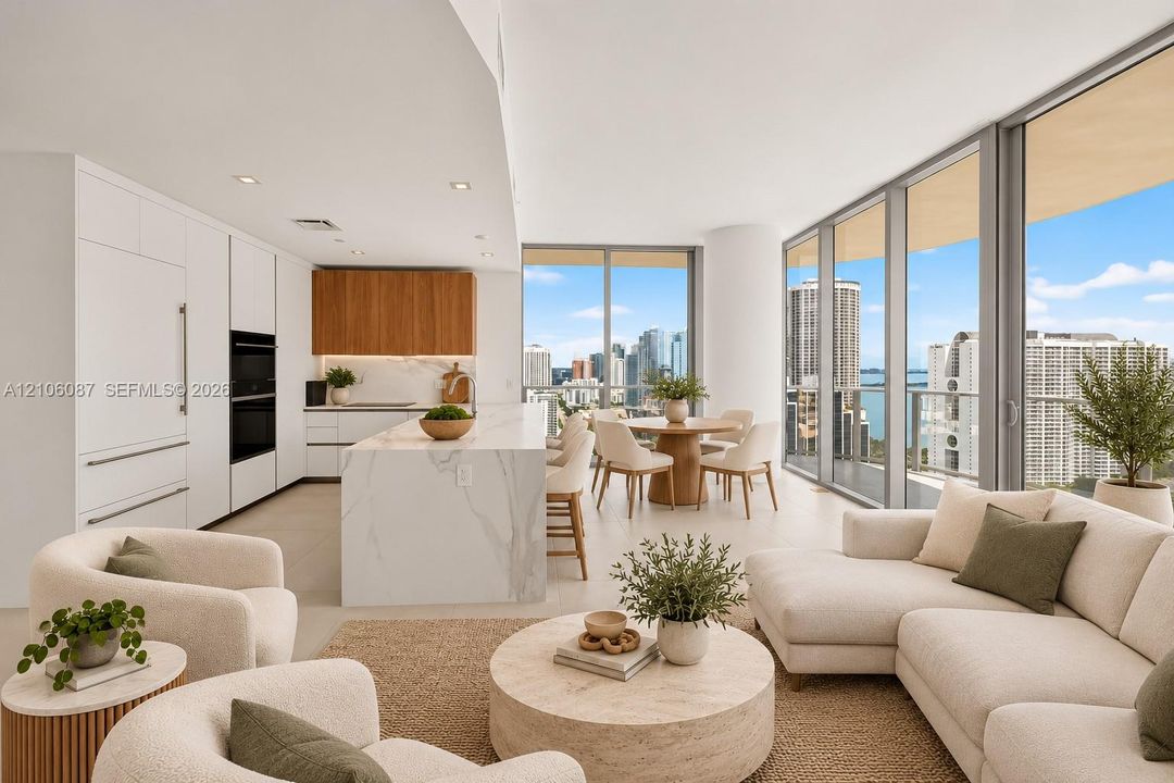 Open-concept kitchen featuring an oversized stone-topped waterfall island, custom flat-panel cabinetry, built-in appliances, and floor-to-ceiling windows