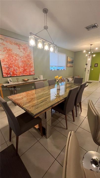 Ceramic tile flooring, industrial-style four-light pendant fixture, and recessed lighting