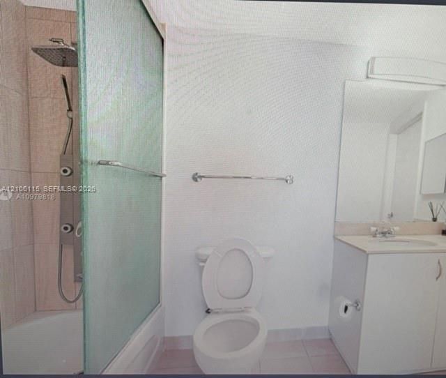 Bathroom featuring a multi-jet shower panel with rainfall showerhead, frosted glass sliding tub enclosure, tiled shower surround, vanity with integrated basin, and large wall-mounted mirror