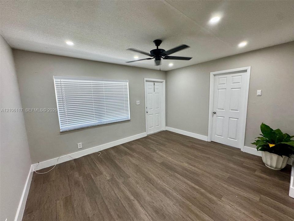 Interior space featuring wood-finish flooring, recessed lighting, a ceiling fan, and six-panel interior doors