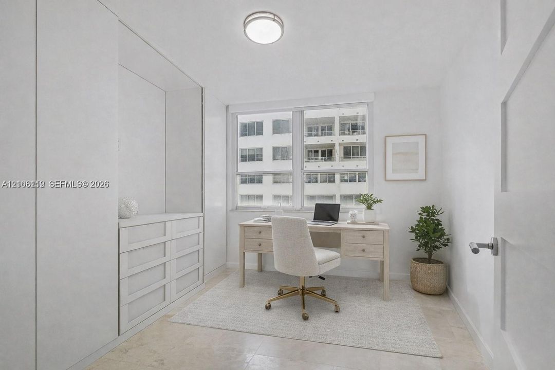 Floor-to-ceiling built-in cabinetry, large window, flush-mount ceiling lighting, and neutral stone-finish flooring
