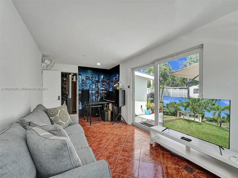 Interior space featuring tile flooring, sliding glass doors, and a built-in closet