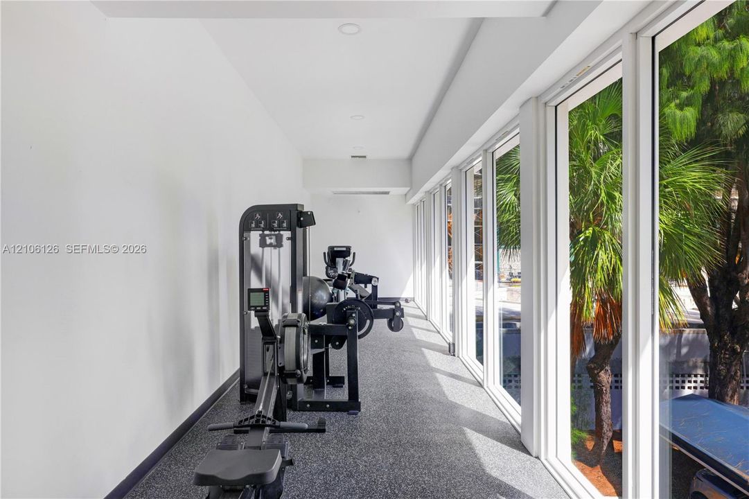 Expansive floor-to-ceiling windows, recessed lighting, and durable flooring