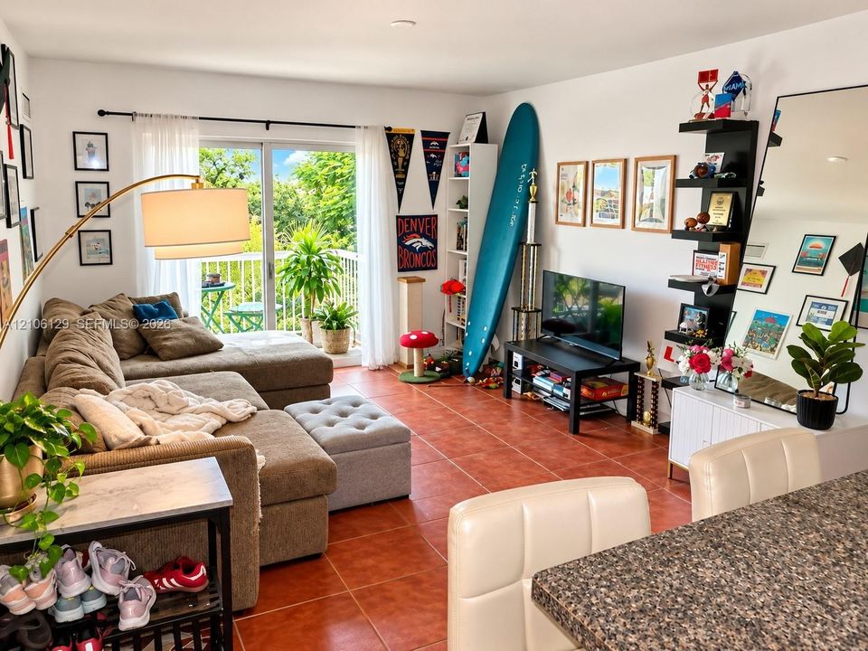 Ceramic tile flooring, sliding glass patio door, and balcony with metal railing