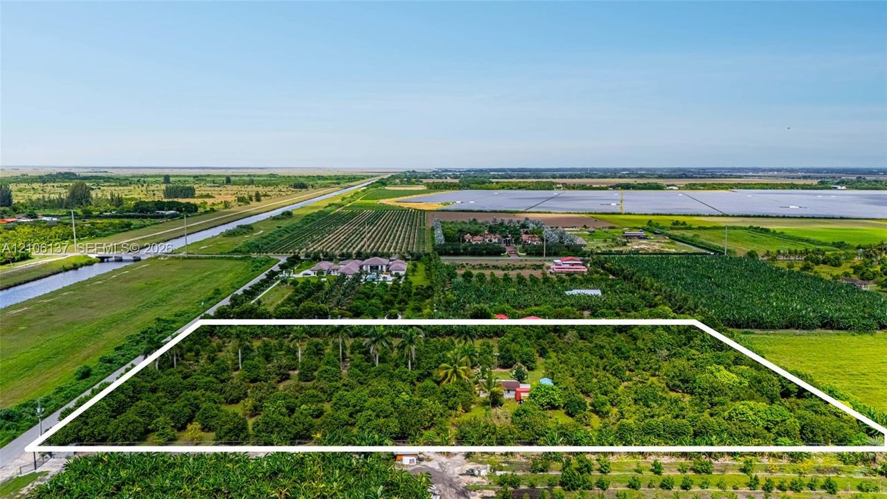 Expansive acreage featuring mature citrus trees and established tropical landscaping