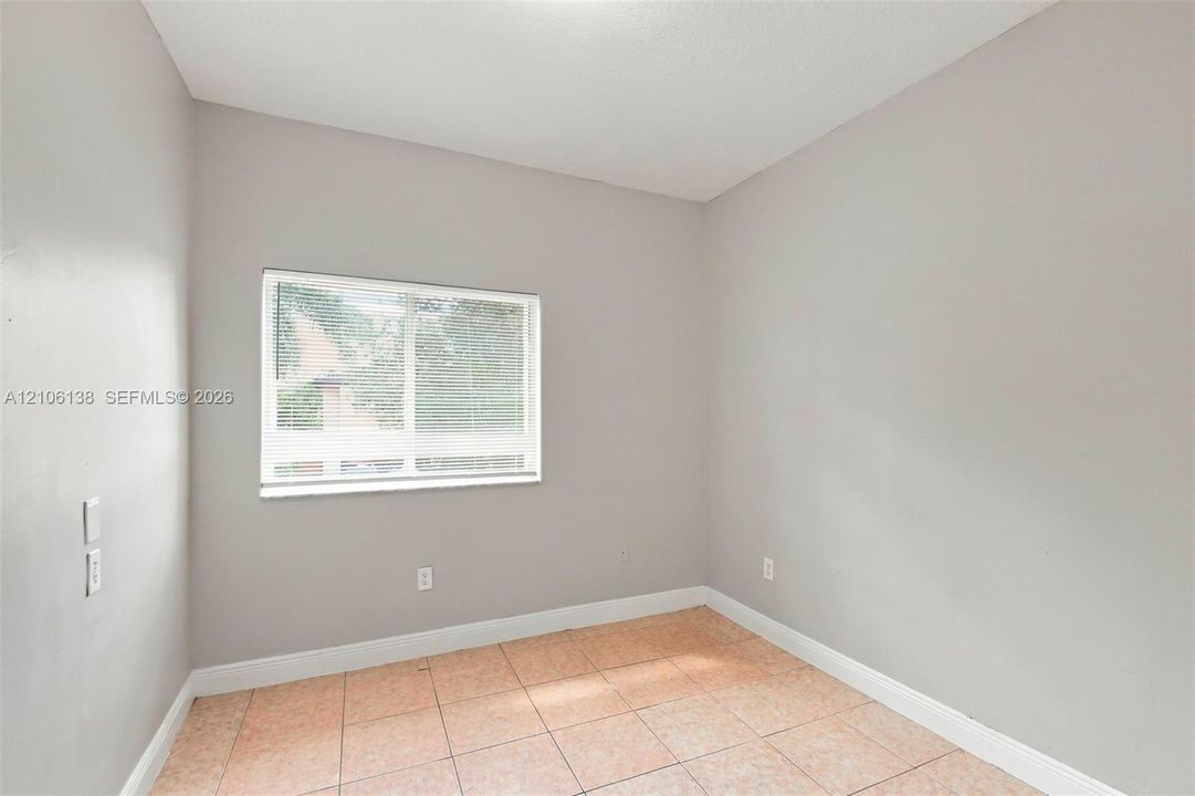 Neutral-toned interior walls, ceramic tile flooring, and horizontal sliding window