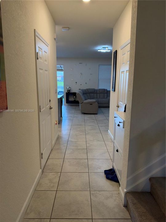 Ceramic tile flooring, white six-panel interior doors, and neutral wall tones