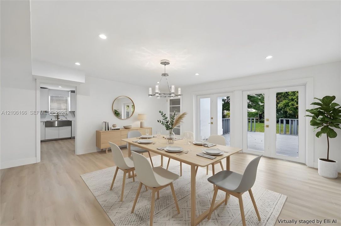 Dining area featuring wood-finish flooring, recessed lighting, a modern multi-arm chandelier, and dual glass-paned doors with exterior access