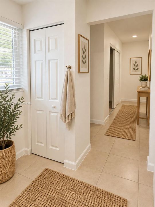 Neutral tile flooring, white six-panel bifold closet doors, and recessed ceiling lighting