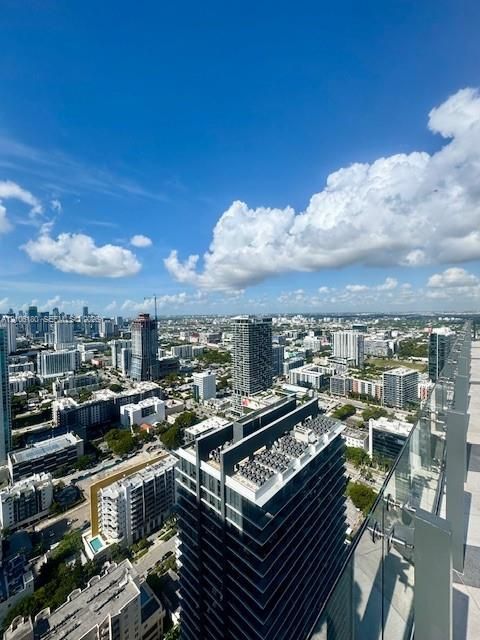 Elevated terrace featuring glass railings and expansive urban skyline scenery