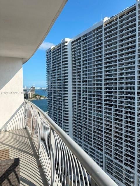 Private balcony with custom vertical metal railing overlooking the coastal waterway