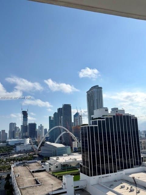 High-rise urban landscape featuring a panoramic skyline, architectural arches, and skyscraper density