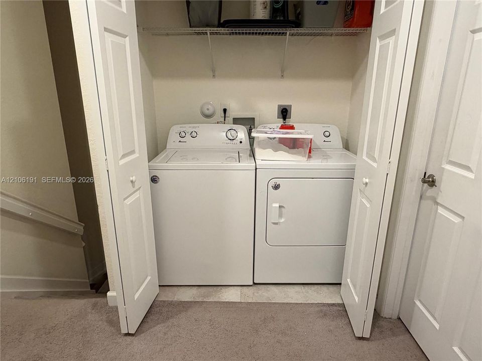 Laundry closet featuring bifold doors and built-in wire shelving