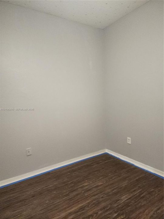 Neutral-toned wall finish and wood-finish flooring