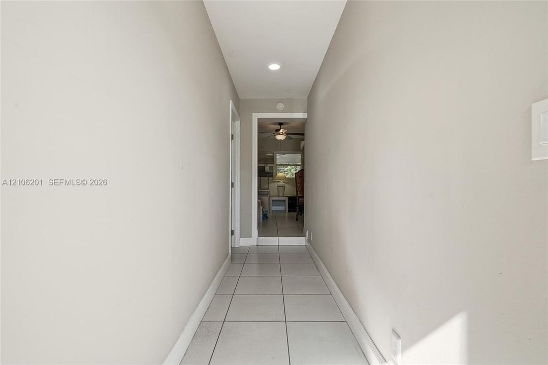 Hallway featuring ceramic tile flooring, recessed ceiling lighting, and neutral wall paint